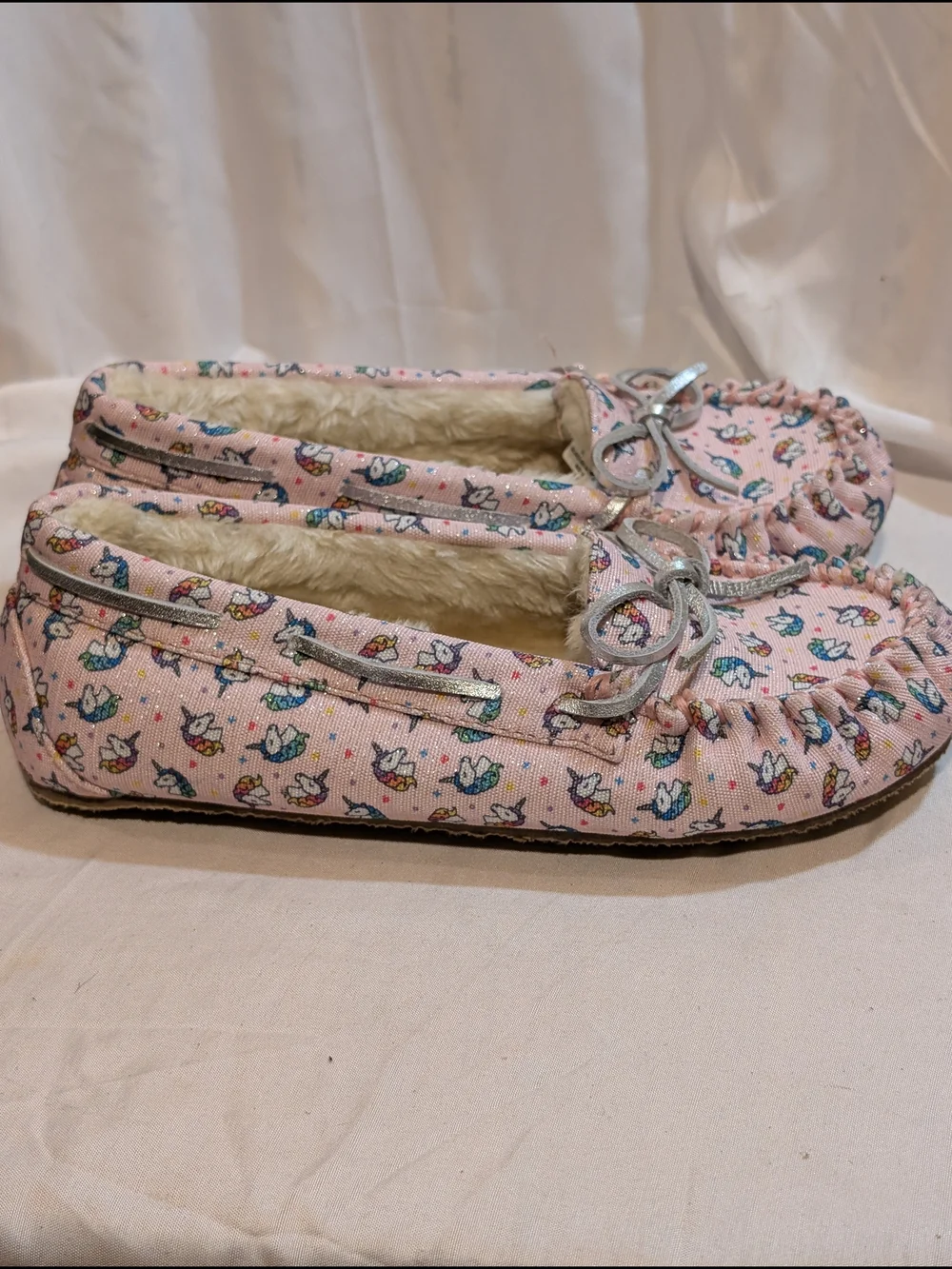Minnetonka Pink Unicorn Print Moccasin Slippers with Silver Bow Accent